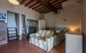 a living room with a couch and a chair at Villa Dallara in Rignano sullʼArno +32 photos