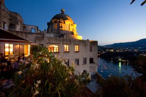 a building with a dome on top of it at night at Albergo Il Monastero in Ischia