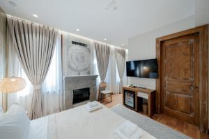 een slaapkamer met een bed en een open haard bij Vintage Boutique Hotel in Korçë