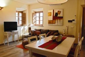 a living room with a table and a couch at Casale Olea in Massarosa