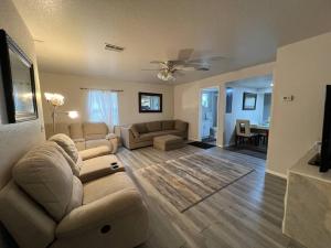 a living room with a couch and a living room with a table at Home in Kissimmee with Huge Backyard in Kissimmee