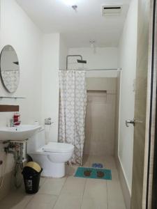 a bathroom with a toilet and a sink at Centro Tower - 2 Bedroom Fully Furnished in Manila