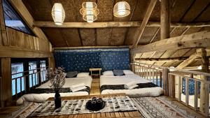 a bedroom with two beds in a cabin at Ho May Garden Retreat - Moc Chau in Mộc Châu