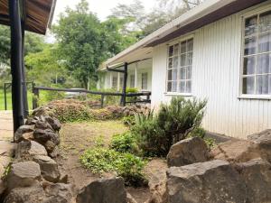 a house with rocks in front of a house at My Lily Cottage Naivasha in Naivasha