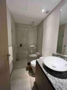 a bathroom with a sink and a toilet and a shower at MAR DEL RIO - Torre Península - Playa privada in Conchal +26 photos