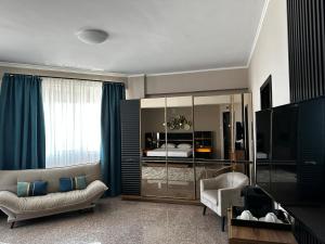a living room with a couch and a bed at Vila Aquamarine in Eforie Nord