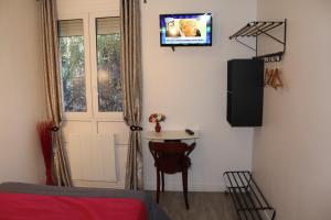 a room with a bed and a television at Le Kleber in Montreuil