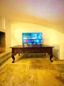 a television sitting on top of a wooden table at Il Serafino Holiday Suites in Bari +41 photos