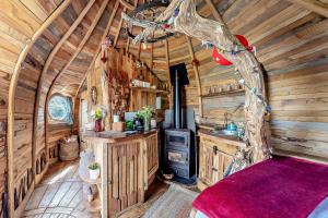 a kitchen with a stove in a log cabin at HOBLEY House Holiday in Craven Arms