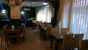 a dining room with tables and chairs in a restaurant at Mevlana Hotel in Konya
