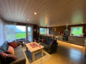 a living room with a couch and a table at Heinåli Hytta in Isfjorden