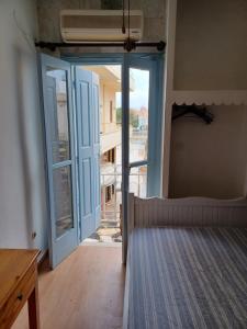 an open door to a room with a bed in it at Old town room 4 in Rethymno