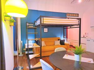 a living room with a bunk bed and a table at Loft centro storico in Turin