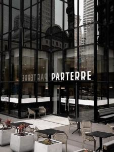 a building with tables and chairs in front of it at Mint House Dallas Downtown By Kasa in Dallas +35 photos