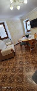 a living room with a bed and a table and a couch at Casa Rosa in Pescocostanzo +1 photo