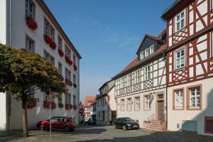 a group of buildings with cars parked in a street at Hotel Restaurant Goldener Engel in Heppenheim an der Bergstrasse
