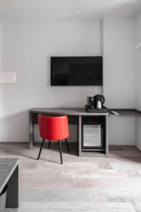 Un televizor și/sau centru de divertisment la Corso49 Boutique Rooms