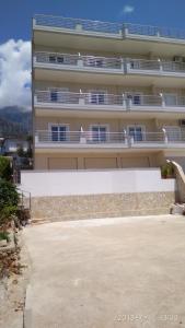 a large building with balconies on the side of it at El Doro Rooms in Dhërmi