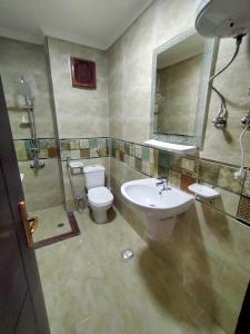 a bathroom with a sink and a toilet and a mirror at برتو جولف مارينا in El Alamein