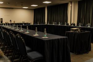 a long table in a room with black tables and chairs at Hampton Inn By Hilton Celaya in Celaya