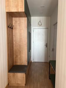a room with a wooden door and a hallway at Bamboo Beach Tsikhisdziri in K'obulet'i
