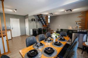 a dining room with a table and some chairs at Cabana Allegro in Moisei +38 photos