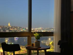a table in front of a window with a view of a city at The Haliç Bosphorus Hotel in Istanbul