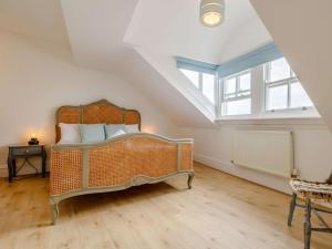 a bedroom with a large bed in a attic at The Penthouse Westhaven Aberdyfi in Aberdyfi