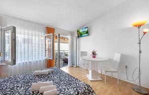 a bedroom with a bed and a table in a room at Stunning Apartment In Vodice in Vodice