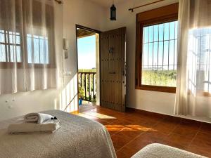 a bedroom with a bed and a large window at Vista al faro in Cádiz