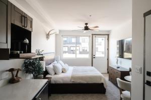 a bedroom with a bed and a ceiling fan at New Luxe Condo - Hot Tub - Minutes to WP! - Fraser in Fraser