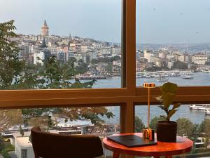 a table in a window with a view of the water at The Haliç Bosphorus Hotel in Istanbul