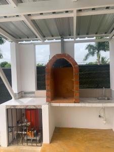 an outdoor kitchen with a pizza oven on a patio at Villa Piña Alojamiento rural in San Rafael