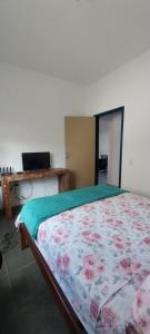 a bedroom with a bed and a desk at Casa da Nina in Tiradentes