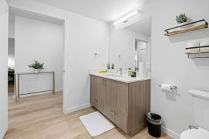 a bathroom with a sink and a mirror at Comfy 1bd1ba Riverside Apt W Queenbdlaundrytv in Spokane +24 photos