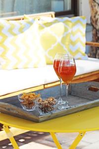 a tray with a wine glass and nuts on a table at Eulenschlupf Wellnesswohnung Schwarzwald mit Sauna, Homekino & Hot Tub nahe Schweiz für Paare in Ühlingen-Birkendorf