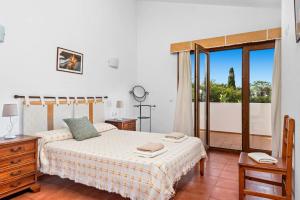 a bedroom with a bed and a large window at Villa Angel by Villa Plus in Son Xoriguer