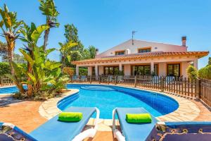 a villa with a swimming pool in front of a house at Villa Angel by Villa Plus in Son Xoriguer