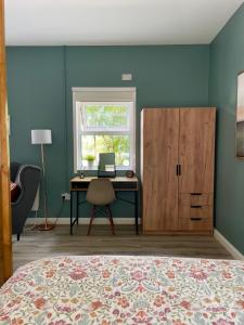 a bedroom with a bed and a desk and a window at Studio in Letterkenny