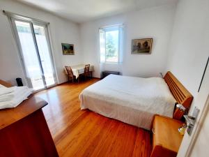 Postel nebo postele na pokoji v ubytování Ampie camere Locarno