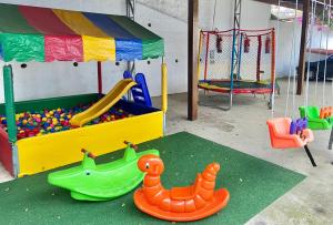 a play room with toys and a toy dinosaur at Casa do Pinheiro Petrópolis in Petrópolis