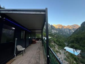a balcony of a house with a view of the mountains at Guest House Waterfall Theth in Shkodër +14 photos