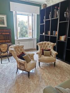 a living room with two chairs and a couch at Gemstone Colors Flat in Chiavari