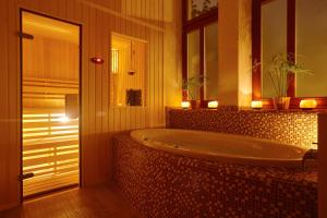 a bathroom with a large tub with candles in it at Wellness Apartment De Luxe in Liberec