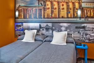 a bedroom with a bed with two pillows at JC Rooms Santo Domingo in Madrid
