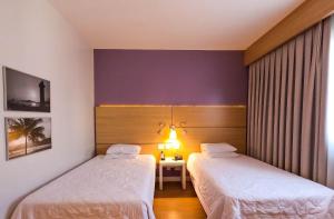 Stay Inn Santos Sua acomodação com cara de Hotel客房内的一张或多张床位