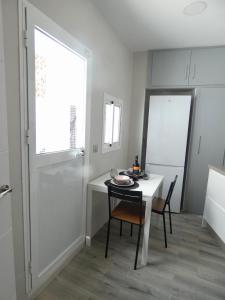 a dining room with a table and chairs and a window at Casa Monturrio in Moguer +21 photos