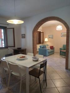 a dining room and living room with a table and chairs at la casa di Rosa in Selvatelle