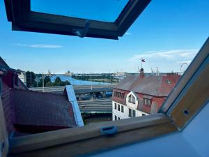 a view of a city from a window of a building at ZAMKOWE TARASY Apartamenty Old Town by stayly in Szczecin