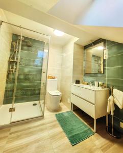 a bathroom with a shower and a toilet and a sink at City Vendégház Balatonfüred in Balatonfüred